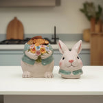 Load image into Gallery viewer, Blue Bunny Cookie Stasher Ceramic bunny figurines with flower baskets for Easter decor | Hand-painted ceramic bunny| Whimsical spring decor ceramic bunnies | Bunny Cookie Stasher | Cute cookie Stasher | Home Decor | Kitchen Ware