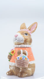 Load and play video in Gallery viewer, Orange Bunny Cookie Stasher - Ceramic bunny figurines with flower baskets for Easter decor | Hand-painted ceramic bunny| Whimsical spring decor ceramic bunnies | Bunny Cookie Stasher | Cute cookie Stasher | Home Decor | Kitchen Ware
