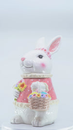 Load and play video in Gallery viewer, Pink Bunny Cookie Stasher - Ceramic bunny figurines with flower baskets for Easter decor | Hand-painted ceramic bunny| Whimsical spring decor ceramic bunnies | Bunny Cookie Stasher | Cute cookie Stasher | Home Decor | Kitchen Ware

